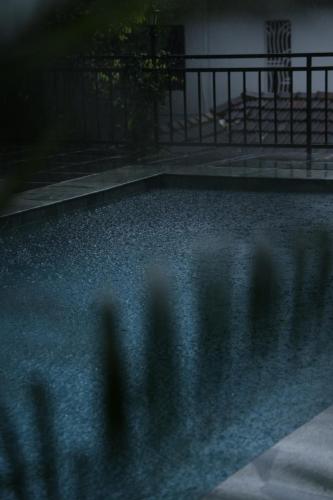 a group of people standing in a pool at night at Vanilla County in Vagamon