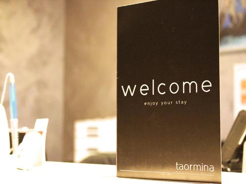 a sign with the words welcome on a table at Hotel Taormina Brussels Airport in Zaventem