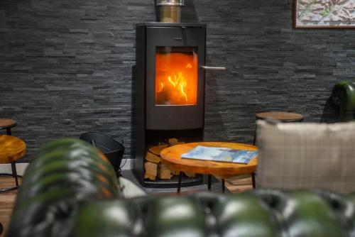 a fireplace in a room with a table and chairs at Glen Nevis Youth Hostel in Fort William