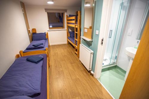 a room with two bunk beds and a sink at Glen Nevis Youth Hostel in Fort William
