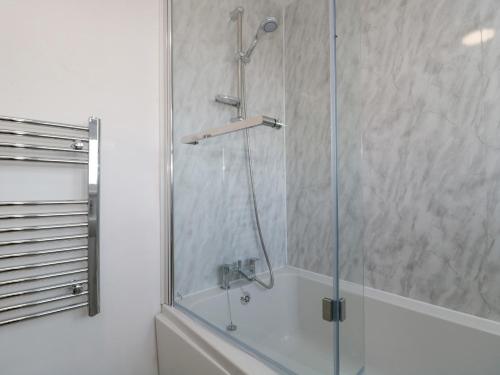 a shower with a glass door in a bathroom at 38 Clyffe Pypard in Swindon