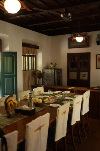 a dining room table with a plate of food on it at Vanilla County in Vagamon