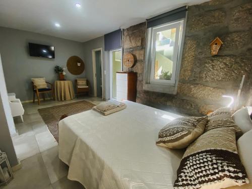 a bedroom with a large white bed and a window at En-Suite Bedroom and Garage in Porto City Center in Porto