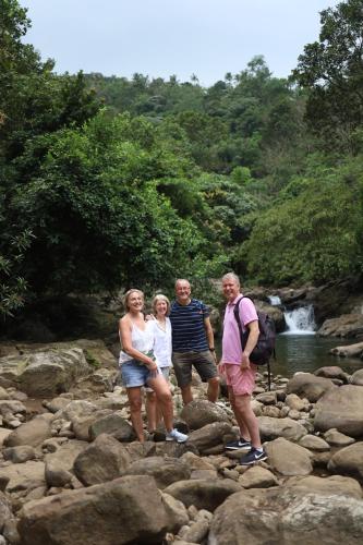 a group of people standing on rocks near a river at Vanilla County in Vagamon