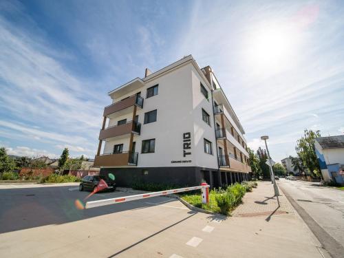 a large white building on the side of a street at TRIO apartment in Piešťany