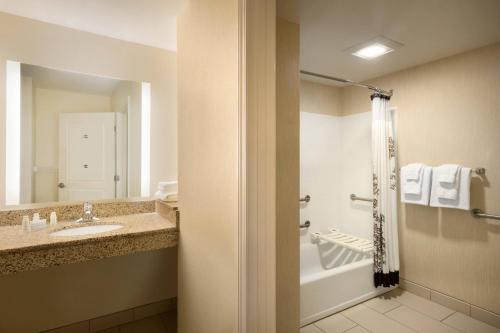 a bathroom with a sink and a tub and a shower at Residence Inn by Marriott Charleston North/Ashley Phosphate in Charleston