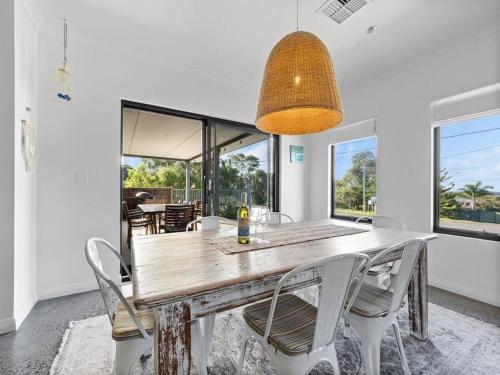 a dining room with a wooden table and chairs at Whale Tails Augusta - stylishly modern in the town of Augusta in Augusta