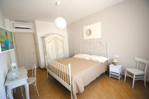 een slaapkamer met een bed, een tafel en een stoel bij B&B Puglia Vista Mare in Impalata