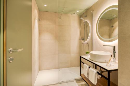 a bathroom with a shower and a sink at Citadines Danube Vienna in Vienna