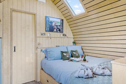 a bedroom with a bed in a wooden wall at The West Front, Cathedral View in Wells