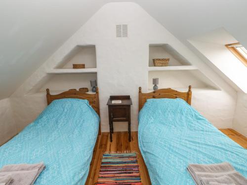 a bedroom with two beds in a attic at Workshop in Goodwick