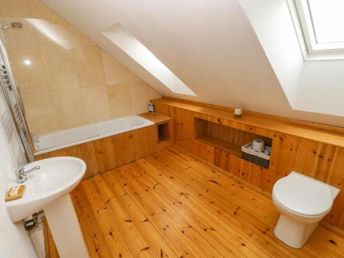 a attic bathroom with a sink and a toilet at Workshop in Goodwick