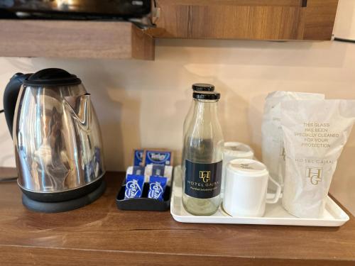 a coffee maker and a bottle on a counter at Hotel Gajraj in Gangtok