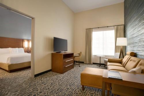 a hotel room with a bed and a television at Residence Inn by Marriott Phoenix Chandler/South in Chandler