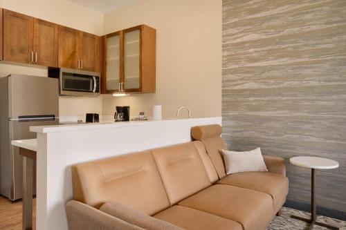 a living room with a couch and a kitchen at Residence Inn by Marriott Phoenix Chandler/South in Chandler