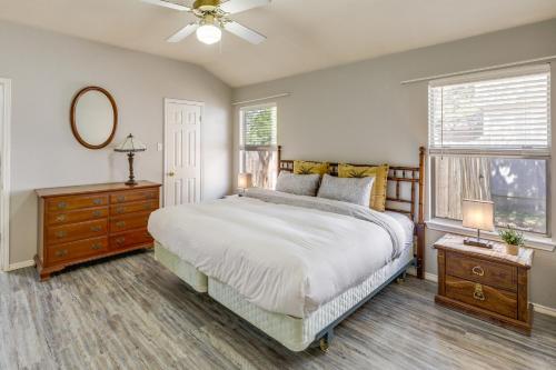 a bedroom with a bed and a dresser and a window at Ideally Located Austin Home with Fenced-In Yard! in Austin