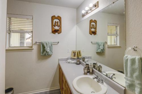 a bathroom with a sink and a mirror at Ideally Located Austin Home with Fenced-In Yard! in Austin
