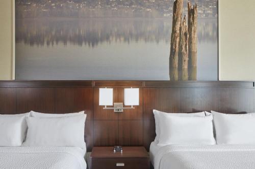 a hotel room with two beds and a painting at Courtyard by Marriott Portland City Center in Portland