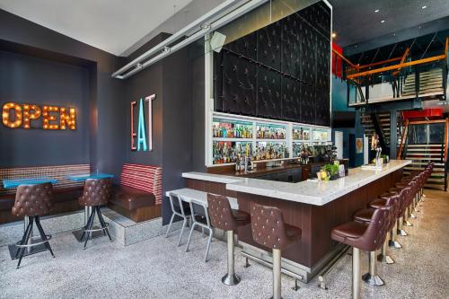 a bar with brown chairs and a counter in a restaurant at Courtyard by Marriott Portland City Center in Portland