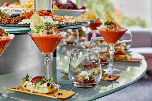 a buffet of food on a glass table with drinks at Courtyard by Marriott Portland City Center in Portland