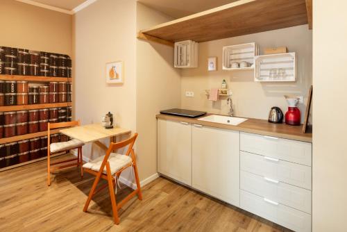 a kitchen with a table and a desk and a table and chairs at Schloss Hertefeld & Hertefeldhof in Weeze