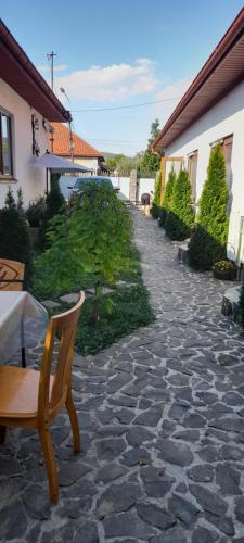 a stone patio with a table and a chair at KOMFORT in Berehove