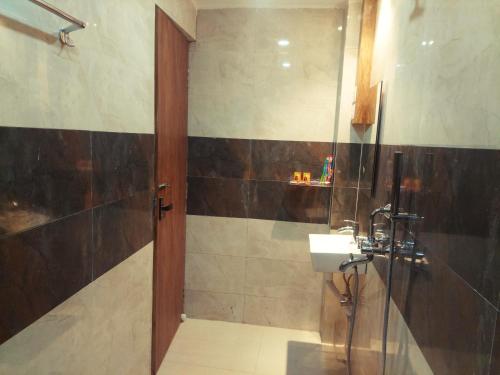 a bathroom with a sink and a shower at DREAM HOTEL in Purulia
