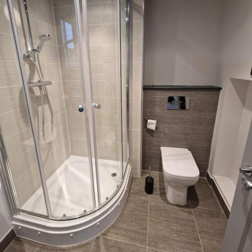 a bathroom with a shower and a toilet at The Queen Street Bunkhouse in Newcastle upon Tyne