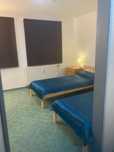 a hotel room with two beds and a large window at Immensee in Ronshausen