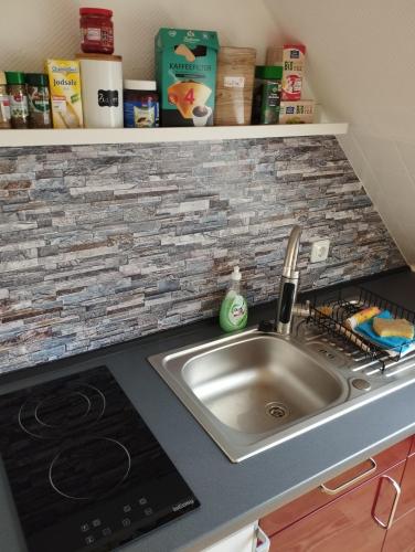 a kitchen counter with a sink and a stove at Apartment Wittorf in Neumünster