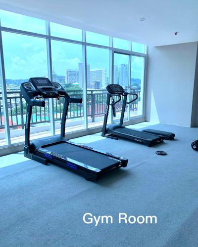 two tread machines in a room with a large window at Wiwi Formosa Residence Nagoya with Balcony-Spacious-Netflix in Nagoya