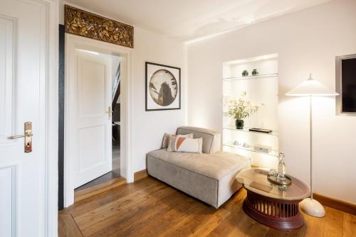 a living room with a couch and a table at Schloss Hertefeld & Hertefeldhof in Weeze
