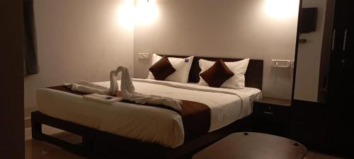 a bedroom with a large bed with a large mirror at HOTEL RAAJ GRAND in Chennai
