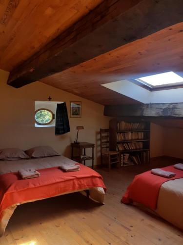 a bedroom with two beds and a skylight at La maison du haut in Ponet-et-Saint-Auban