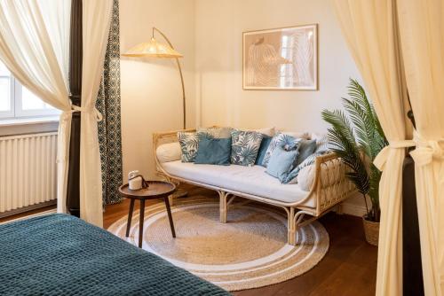 a living room with a couch with blue pillows at Schloss Hertefeld & Hertefeldhof in Weeze
