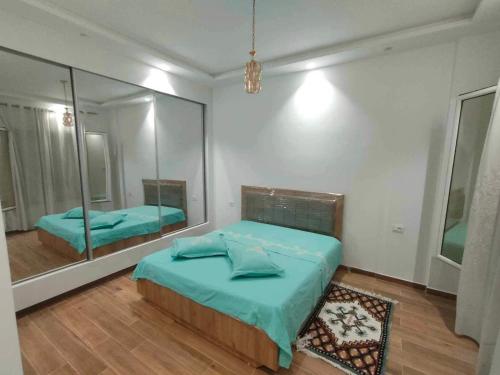 Le Kram的住宿－Dar Al Yaqout，一间卧室配有一张床和一面大镜子