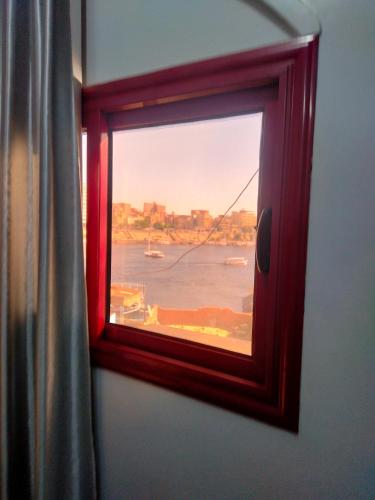 a window in a room with a view of the water at Jamaica Guest House in Aswan