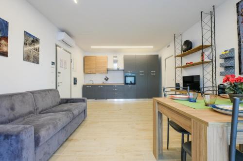 a living room with a couch and a table at BergamoCityCenter 02 in Bergamo