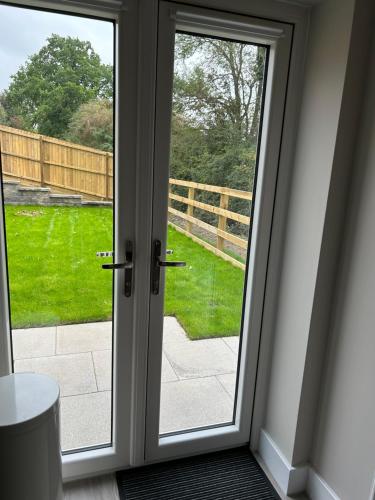 a sliding glass door with a view of a yard at Meadow View in Alfreton
