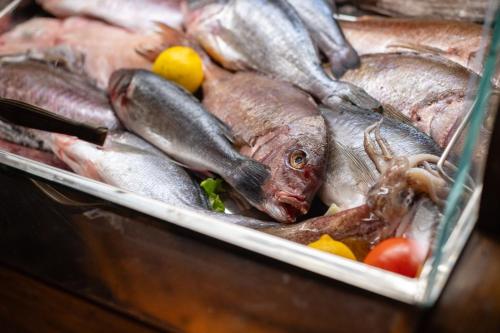 a bunch of fish in a basket on a table at Heritage Hotel Tragos in Trogir