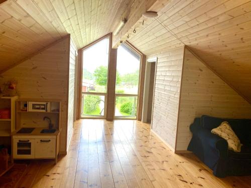 a large room with a large window in a house at Skjerping gårdshus, in Lonevåg