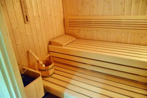 a small wooden sauna with a trash can in it at quiet and central Luxury Villa "JUWEL" with Sauna, at Ski slope! in Sankt Michael im Lungau