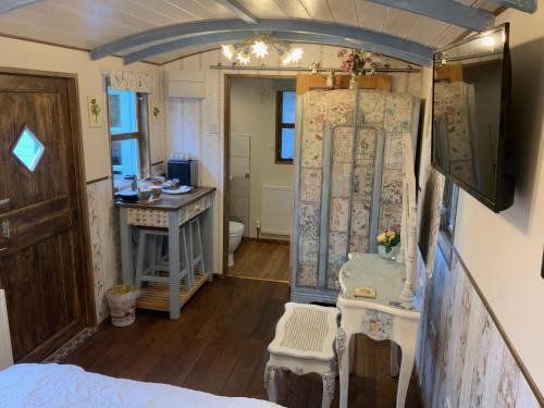 a room with a bed and a table and a counter at Hunt House Rooms in Kilsby