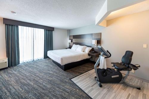 a hotel room with a bed and a desk and a chair at Best Western Plus Wausau Tower Inn in Wausau