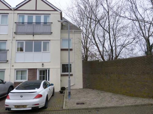 a white car parked in front of a house at The Sawmills, Carlisle - Spacious 4 Bedroom Family House - Free WiFi - & Parking - Walk to Carlisle Castle in Carlisle