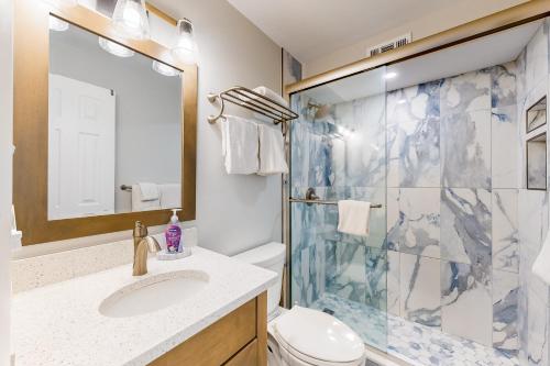 a bathroom with a shower and a sink and a toilet at Jamaica IV 209 in Ocean City