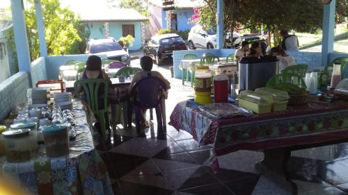 a group of people sitting at a table on a patio at pousada chykos in Barreirinhas