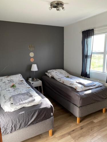 Postel nebo postele na pokoji v ubytování Byggðarhorn