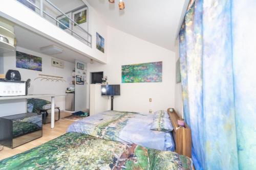 a bedroom with a bed and a loft at Claude Monet Tokyo Shibuya Shinjyuku Wifi Free! in Tokyo