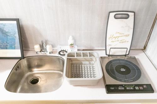 a kitchen counter with a sink and a cell phone at Claude Monet Tokyo Shibuya Shinjyuku Wifi Free! in Tokyo
